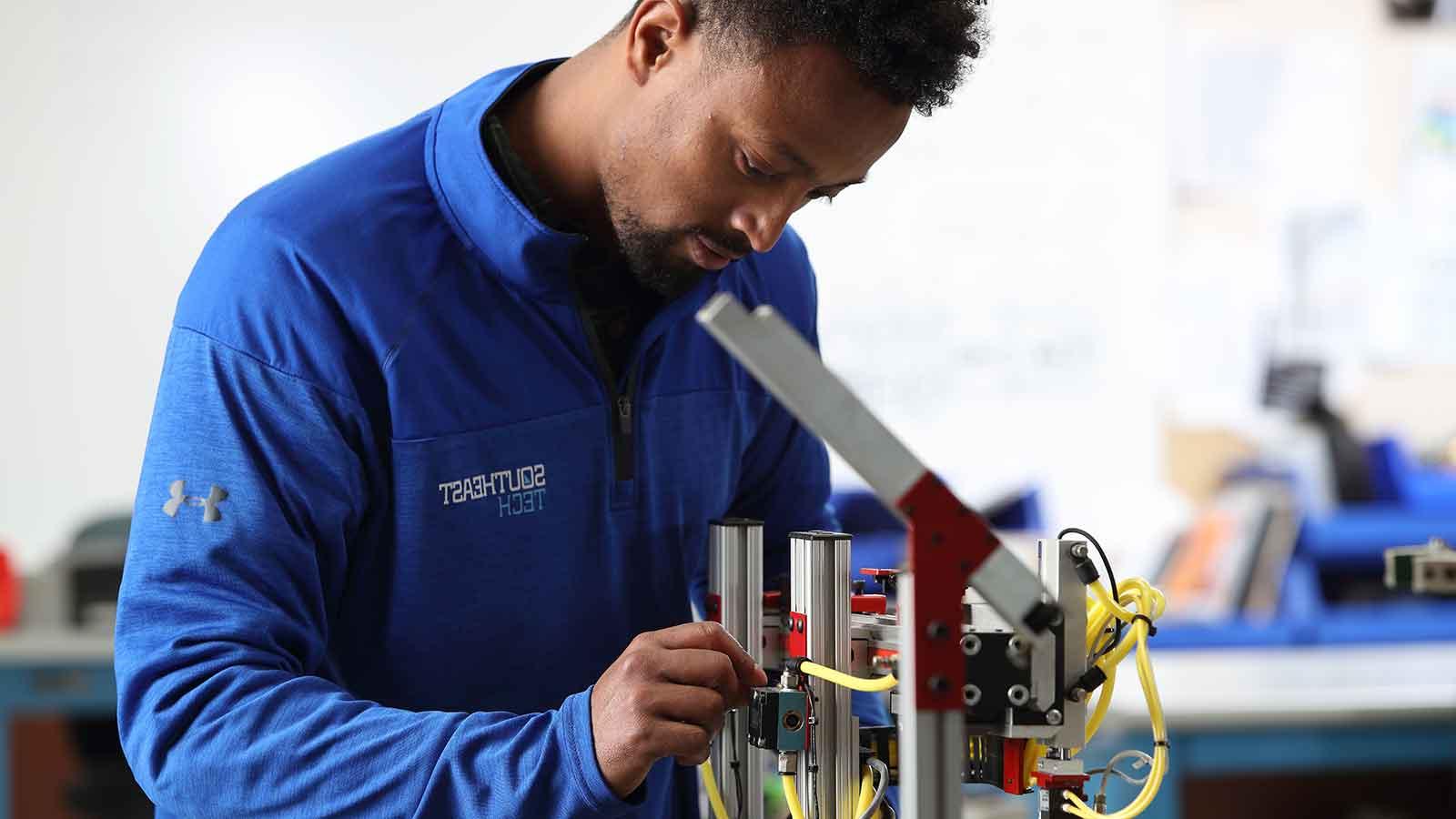 Mechatronics student working on robotic arm